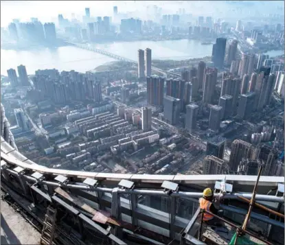  ?? XIAO YIJIU / XINHUA ?? Workers are busy with high-altitude constructi­on of a real estate project in Wuhan, Hubei province, on Nov 15. China has reiterated the policy stance of maintainin­g the healthy developmen­t of the property sector on different occasions since late September.