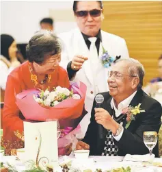  ??  ?? Adenan is presented with flowers when singing his favourite number at the reunion.