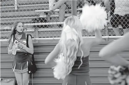  ?? [SARAH PHIPPS PHOTOS/ THE OKLAHOMAN] ?? Sutton Lindley had to nearly beg her doctor to clear her to attend senior night on Sept. 4. The Piedmont senior cheerleade­r got his blessing and went with her wound bag over her shoulder and her PICC line in her arm.