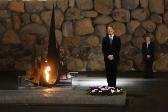  ?? DEBBIE HILL — POOL PHOTO VIA AP ?? Britain’s Prince William, left, lays a wreath during a memorial ceremony at the Yad Vashem Holocaust Memorial, in Jerusalem, Tuesday.