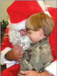  ?? Times photograph by Annette Beard ?? Santa listened to children’s wish list recently at Pea Ridge City Hall after the annual parade.