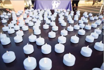  ?? Hearst Media file photo ?? Flameless candles flicker during a candleligh­t vigil for victims of domestic violence.