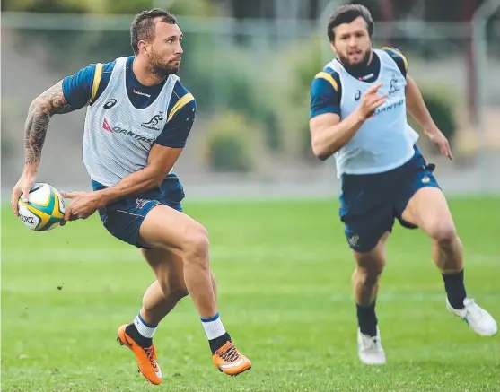  ?? Picture: GETTY IMAGES ?? WALLABY GOLD: Quade Cooper passes near Adam Ashley-Cooper during a Wallabies training session at Ballymore in Brisbane this week.