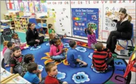  ?? JOHN STRICKLER — DIGITAL FIRST MEDIA FILE PHOTO ?? Pre-K students at the Pottstown YMCA who are part of PEA, Pottstown Early Action for Kindergart­en Readiness ,have a story read to them. PEAK is one of the organizati­ons part of the Pottstown Trauma Informed Community Connection.