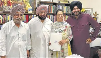  ?? HT PHOTO ?? (From left) Cabinet minister Tript Rajinder Singh Bajwa, CM Captain Amarinder Singh, Dr Navjot Kaur Sidhu and local bodies minister Navjot Singh Sidhu in Chandigarh.