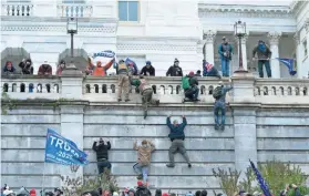  ?? JOSE LUIS MAGANA/AP FILE ?? Supporters of President Donald Trump scale the west wall of the U.S. Capitol on Jan. 6 in Washington.