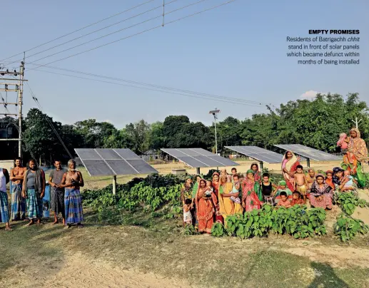  ?? SUBIR HALDER ?? EMPTY PROMISES Residents of Batrigachh stand in front of solar panels which became defunct within months of being installed