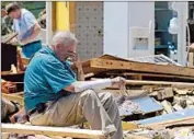  ?? Thomas Graning Associated Press ?? CHARLES MILAM takes a break from searching the wreckage of his home in Tupelo, Miss.