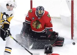  ?? NAM Y. HUH/AP ?? Blackhawks goaltender Corey Crawford makes a save on a shot by Penguins center Evgeni Malkin in the first period Wednesday at the United Center.