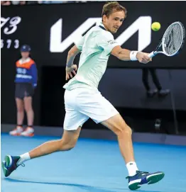  ?? — AP ?? Daniil Medvedev of Russia returns to Nick Kyrgios of Australia during their Australian Open second round match in Melbourne on Thursday.