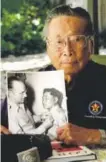  ?? Associated Press file ?? George Sakato in 2000, with a photo from 1945.