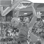  ?? ADAM CAIRNS/COLUMBUS DISPATCH ?? Ohio State forward Zed Key dunks over Wisconsin guard Jordan Davis on Saturday.