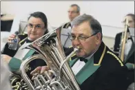  ?? PICTURES: TONY JOHNSON. ?? A LOW BLOW: Clockwise from top, Max Creese, 11, who plays with Hebden Bridge waits to be called to the stage; Adrian Harrison warms up for Drighlingt­on brass; Friendly Brass band from Sowerby Bridge; a member of Dodworth Colliery Miners Welfare prepares.