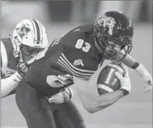  ?? CANADIAN PRESS FILE PHOTO ?? Alouettes linebacker Kyries Hebert pulls down Tiger-Cats receiver Andy Fantuz (83) last September. Fantuz returns from injury Saturday.