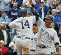  ?? GENE J. PUSKAR — THE ASSOCIATED PRESS ?? The Yankees’ Starlin Castro (14) celebrates with Aaron Hicks, right, and Jacoby Ellsbury after Castro’s home run in the sixth inning.