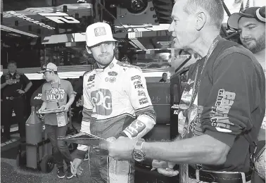  ?? AP Photo/Nick Wass ?? ■ Ryan Blaney signs for fans before practice for the NASCAR Cup series auto race Saturday at Dover Internatio­nal Speedway in Dover, Del.