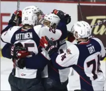  ?? ADRIAN WYLD, THE CANADIAN PRESS ?? Spitfires left-winger Jeremiah Addison is surrounded by teammates, including Julius Nattinen and Sean Day, after scoring a goal against the Erie Otters in the first period of a Memorial Cup round-robin hockey game in Windsor on Wednesday night. Windsor...