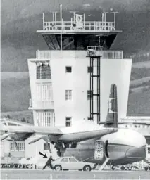  ??  ?? The control tower at Dunedin Airport during the hostage crisis. The arrow shows a member of the armed offenders squad moving for cover behind a police car.