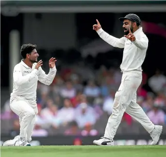  ?? GETTY IMAGES ?? Kuldeep Yadav, left, and Indian captain Virat Kohli celebrate another wicket.