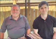  ?? Dan Sewell / Associated Press ?? This photo from June 26 shows Buck Newsome, left, a baby boomer, and his son, Chris Newsome, of the millennial generation, as they pose for a photo while having lunch together in Newtown, Ohio.