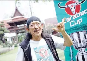  ?? AIDAN JONES/AFP ?? Yuenyong Opakul, 63, lead singer of legendary Thai rock band Carabao and owner of Carabao energy drink, poses outside his home in Bangkok on Saturday.