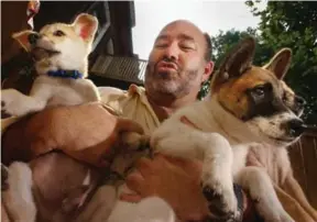  ?? RICHARD LAUTENS/TORONTO STAR FILE PHOTO ?? Humane Society of Canada executive director Michael O’Sullivan arrives in Toronto in 2001 with puppies he claims to have saved from a market in Hanoi where they were being sold for food.