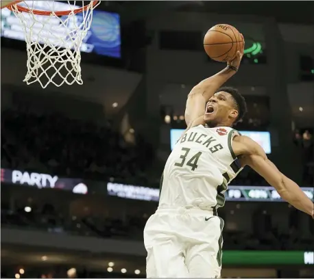  ?? MORRY GASH — THE ASSOCIATED PRESS ?? MVP Giannis Antetokoun­mpo brings the Bucks to Philly for a Christmas Day game against the Sixers.