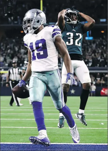  ?? — GETTY IMAGES ?? Cowboys wide receiver Amari Cooper runs for a touchdown past Eagles’ Rasul Douglas in overtime for a 29-23 win at AT&amp;T Stadium in Arlington, Texas, yesterday.