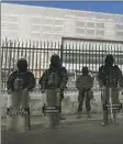  ?? DOLORES OCHOA Associated Press ?? SOLDIERS GUARD the National Assembly in Quito, Ecuador.