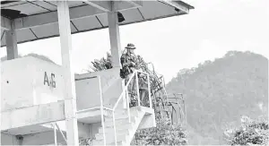  ?? — Gambar Bernama ?? PANTAU: Lans Koperal Amir Haidley Mohd Kamal, 27, bertugas di Menara Tinjau menjaga sempadan Malaysia-Thailand di Padang Besar.
