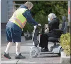  ??  ?? The Canadian Press
A HandyDART driver wearing a face mask helps an elderly person in North Vancouver.