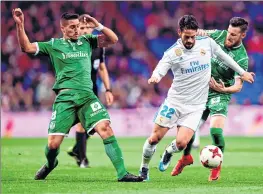  ??  ?? Real Madrid's Isco (C) vies with Leganes' Gabriel Appelt (L) and Unai Bustinza during the Spanish 'Copa del Rey' (King's cup) quarter-final at the Santiago Bernabeu stadium.