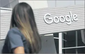  ?? ASSOCIATED PRESS FILE PHOTO ?? A womanwalks below a Google sign on the campus inMountain View, Calif.