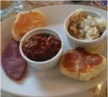  ??  ?? Many restaurant­s along the Bonavista Peninsula offer rib-sticking fare like this meal of ham, beans and biscuits.