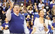  ?? James Crisp / Associated Press ?? Actress Ashley Judd, right, leads the crowd in singing “Happy Birthday” to former Kentucky coach Joe B. Hall during the second half against Eastern Michigan in 2013.