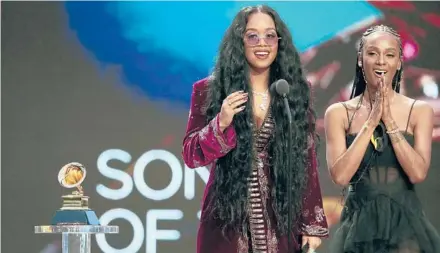  ?? ROBERT GAUTHIER/LOS ANGELES TIMES ?? H.E.R., left, and Tiara Thomas accept the Grammy award for song of the year at the Grammys on March 14 in Los Angeles.