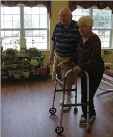  ?? AP PHOTO/NAM Y. HUH ?? Chuck Schwarz (left), takes walk with his wife Cathy at Heritage Woods of South Elgin on Friday in South Elgin, Ill. Medicaid Americans 65 and older and the disabled make up about a quarter of Medicaid recipients but account for two-thirds of its...