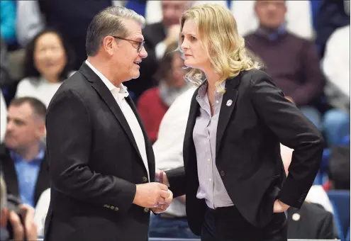  ?? Jessica Hill / Associated Press ?? UConn coach Geno Auriemma, left, talks with Tennessee coach Kellie Harper before a game in Hartford last January.