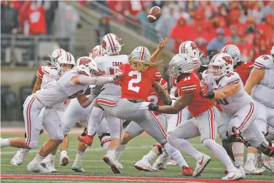  ?? JAY LAPRETE/ASSOCIATED PRESS ?? Ohio State defenders Chase Young (2) and Tyreke Smith cause Wisconsin quarterbac­k Jack Coan to fumble on fourth down during the second half Saturday in Columbus, Ohio. Ohio State beat Wisconsin 38-7.