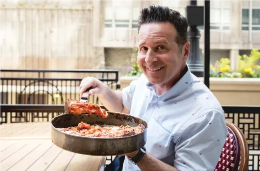  ?? PAT NABONG/SUN-TIMES ?? Steve Dolinsky, also known as James Beard Award-winning food reporter “The Hungry Hound,” enjoys a deep-dish pie at Labriola Chicago.