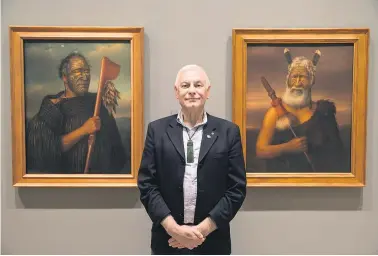  ?? Picture / Peter Meecham ?? Benjamin Pittman is flanked by paintings of his ancestors, Tamati Waka Nene ( left) and Eruera Maihi Patuone.