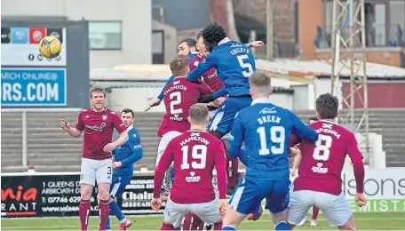  ??  ?? Ayo Obileye rises from the pack to head home the first of his double for Queen of the South at Gayfield