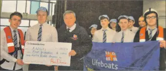  ?? ?? 2014: Patrick Feeney, left, and Ryan McCraig presented George Bradley, lifeboat operations manager at Campbeltow­n with a cheque for £559.