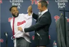  ?? JOSE F. MORENO — FOR THE ASSOCIATED PRESS ?? New Phillies manager Gabe Kapler, right, tries to press Carlos Santana into his new uniform top at Citizens Bank Park Wednesday.