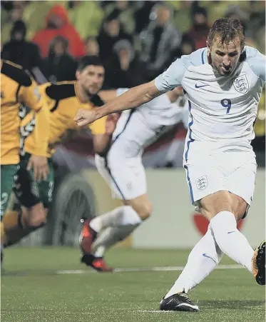  ??  ?? Harry Kane slams home England’s penalty winner against Lithuania in Vilnius last night.