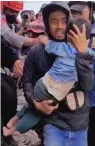  ?? ?? A video grab shows a six-yearold boy being pulled out of the rubble in Cianjur, West Java. — afp