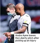  ??  ?? Andre Ayew leaves the Liberty pitch after picking up an injury