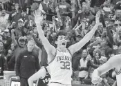  ?? DARRON CUMMINGS AP ?? Indiana’s Trey Galloway celebrates after the Hoosiers defeated No. 1 Purdue 79-74 in Bloomingto­n, Ind.