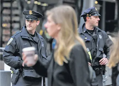  ?? Paul Chinn / The Chronicle ?? Police Officers Alan Katz (left) and Chris Simpson patrol on foot at Powell and Market streets in S.F.