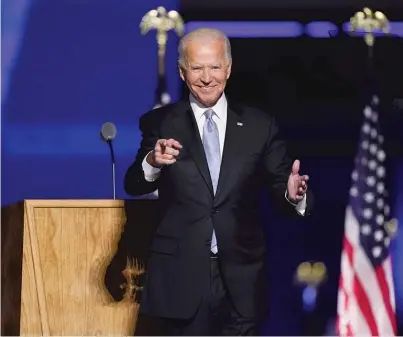  ?? ANDREWHARN­IK/AP ?? President-elect Joe Biden stands on stage after speaking last Saturday inWilmingt­on, Delaware.